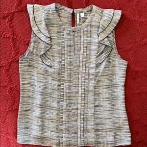 Black and white sleeveless blouse.